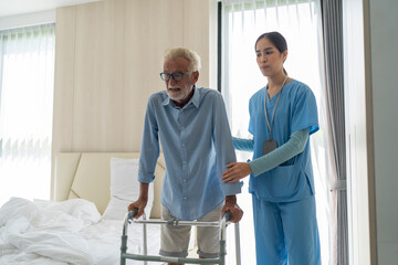 Asian nurse helping senior man go in bed