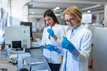 Modern Medical Research Laboratory: Female Scientist Working with Micro Pipette, Using Digital Tablet for Test Sample Analysis. Advanced Scientific Lab for Medicine, Biotechnology Development.