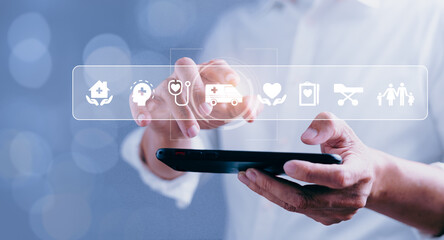 Businessman touching medical service icons with modern interface on mobile phone