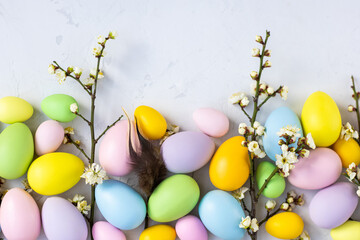 Stylish background with colorful easter eggs on gray concrete background. Flat lay, top view, mockup, overhead, template