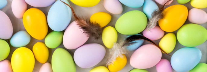 Stylish background with colorful easter eggs on gray concrete background. Flat lay, top view, mockup, overhead, template