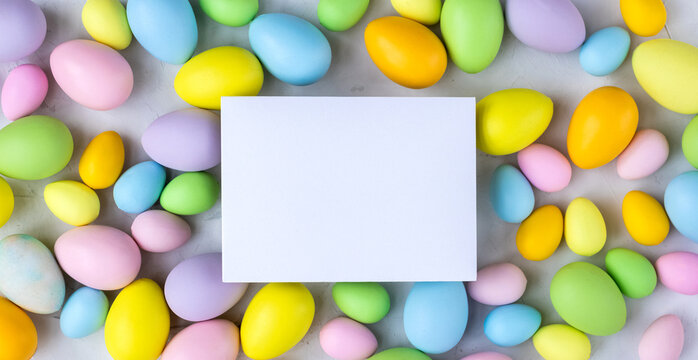 Stylish background with colorful easter eggs on gray concrete background. Flat lay, top view, mockup, overhead, template