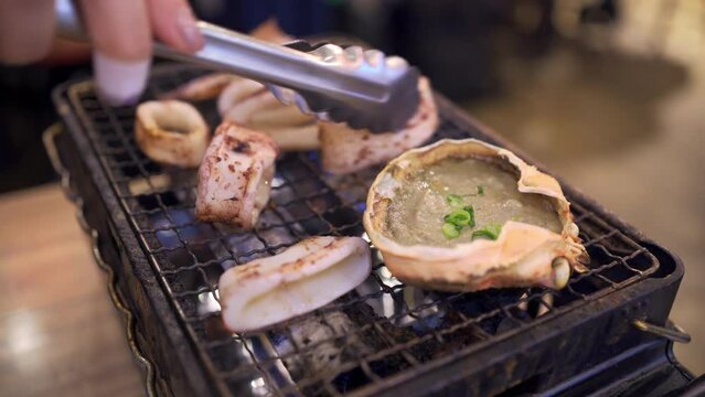 Kani Miso and baked squid on a grill
