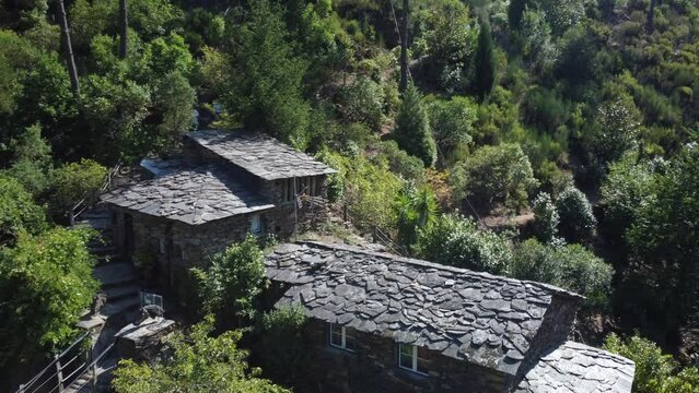 Drone flyover suspended Foz d&acute;&eacute;gua bridge towards schist Houses in historic village. Portugal