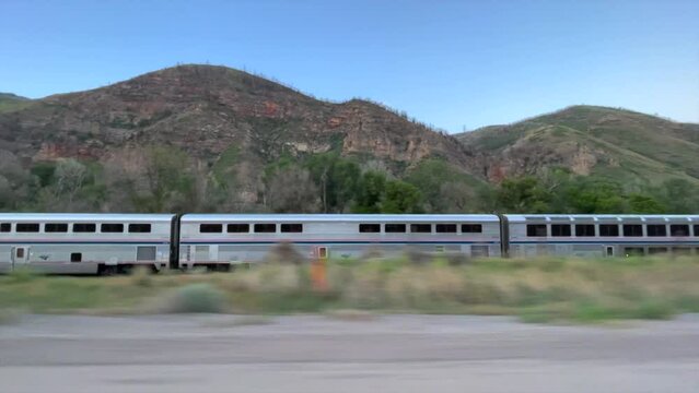 amtrak train speeds through the desert tracking shot