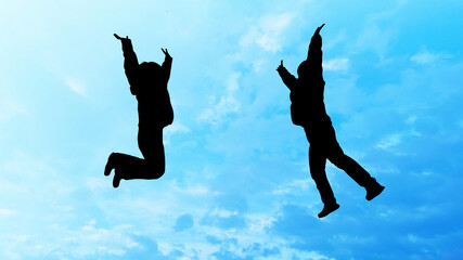 Fototapeta na wymiar ジャンプする2人の女性シルエット_青空背景