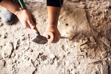 Man with iron hammer breaking concrete. Construction concept