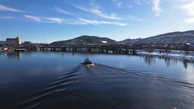 А boat sailing in the river in Drammen,  Norway.