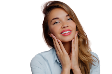 Photo of lovely young female model touches gently chin with both hands, smiles gently, has tender look, long hair combed on right side, wears professional makeup, isolated over purple background