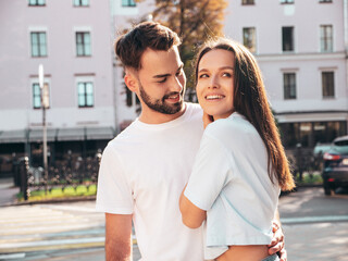 Smiling beautiful woman and her handsome boyfriend. Woman in casual summer jeans clothes. Happy cheerful family. Female having fun. Sexy couple posing in the street at sunny day