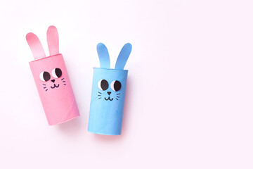 Holiday easy DIY craft idea for kids. Toilet paper roll tube toy's cute rabbit's on minimal background banner. Creative Easter, Christmas decoration eco-friendly, reuse, recycle handmade concept
