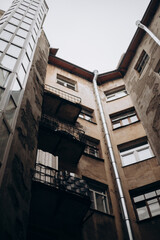 Shabby gray courtyards and gates of a big city in cloudy weather.