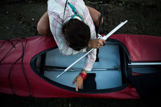 A woman sets up her kayak on the foreshore of the industrial part of Khabarovsk in far East Russia.