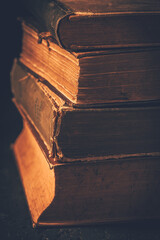 Vintage books stack on old wooden surface