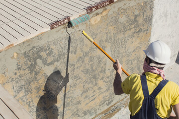 Applying epoxy paint on a surface of a pool