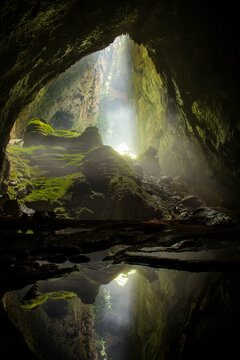 A sunbeam enters midday through the first doline in Hang Son Doong, Vietnam.