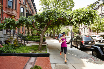 A woman running in the Back Bay neighborhood of Boston, MA.