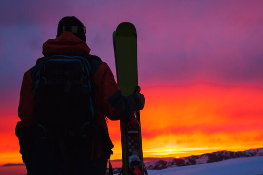 Skier looking at view of sky at sunset, La Parva, Santiago Province, Chile