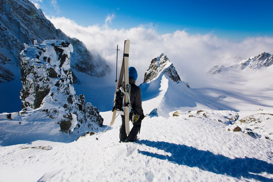 Man going down mountain through snow, South Island, New Zealand