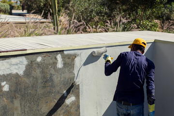 Applying epoxy paint on a surface of a pool