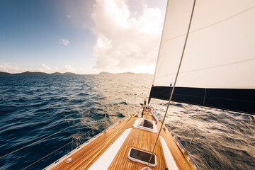 Deck view of a wooden sail boat sailing in calm sea in the Caribbean