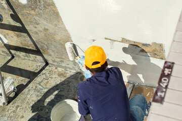Applying epoxy paint on a surface of a pool