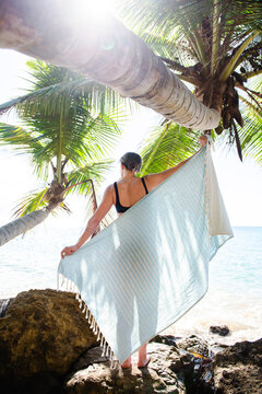 Solo Woman in a bikini with towel at the beach in Puerto Rico