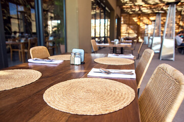 Table setting: fork, spoon and knife with napkins on wooden table. No plate