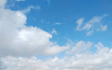 Fototapeta premium Beautiful blue sky with white fluffy clouds.. Natural blue sky background with large and tiny clouds.