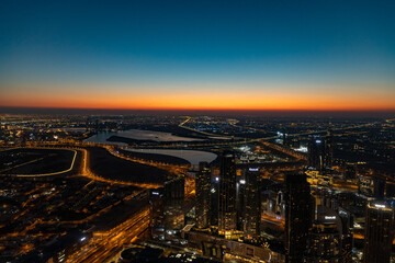 city skyline at sunrise of dubai from the burj khalifa