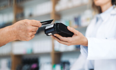 Pharmacist receiving a credit card payment in a chemist