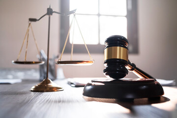 Judge hammer and scale balance on judge work desk.