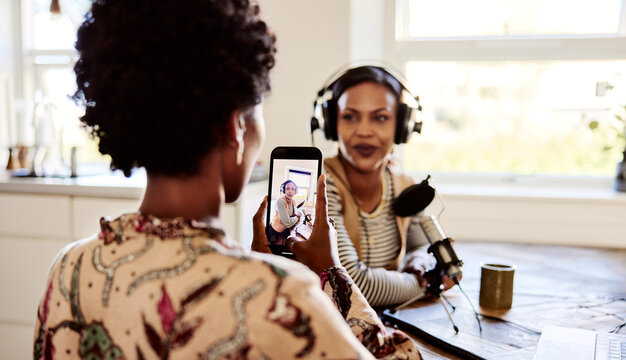 Woman taking video of a friend's podcast
