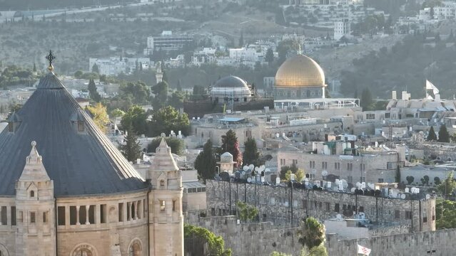 Aerial view of mosques churches with the Dome of the Rock revealing behind Jerusalem