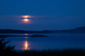 Moody midnight moon at the Finnish archipelago, Baltic Sea.
