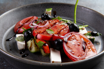 Tomatoes and cheese cubes in a plate.