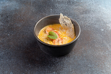 Cream soup with shrimps in a bowl.