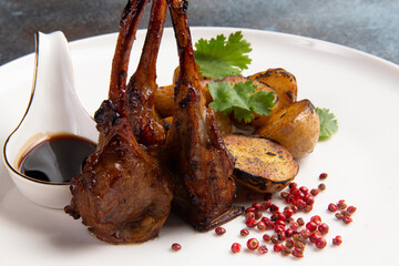 Cooked rack of lamb and baby potato in a plate.