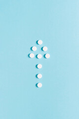 Scattered white pills on blue background. Mock up for special offers as advertising, web background or other ideas. Medical, pharmacy and healthcare concept. copyspace. Empty place for text or logo