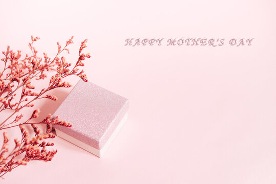 Happy mother's day, women's day or birthday pastel colors background. Floral flat lay minimalism greeting card. Mockup. Beautiful natural flowers on a plain background.