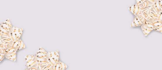 Fototapeta premium Banner with golden ribbon bows scattered on a blue background.