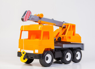 Lift truck. Multi-colored children's toys plastic trucks on a white background.