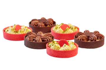 Sweet dessert: Tarts, Tartlets. An assortment of bright red baskets and dark brown ones with a sweet filling of cream and a variety of nuts. Close-up