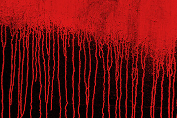 Red paint running down the black wall