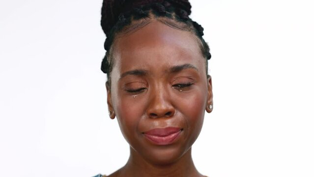Black woman, face and crying and sad with depression isolated on white background. Mental health, pain with grief and loss, mockup and upset female with emotion, portrait and depressed with stress
