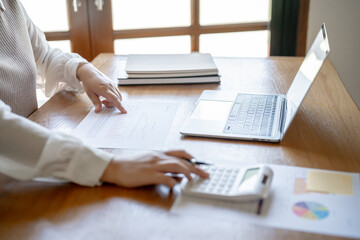 Fototapeta premium Businesswoman Accountant analyzing investment charts Invoice and pressing calculator buttons over documents. Accounting Bookkeeper Clerk&nbsp;Bank Advisor And Auditor Concept