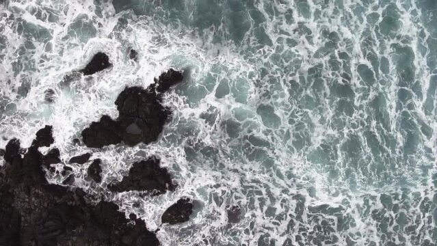 This stock footage captures the raw power of Iceland's ocean waves crashing against the rugged coastline. Perfect for travel films, commercials, and documentaries.