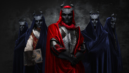 Portrait of secret cult and its members dressed in robes and dark masks.