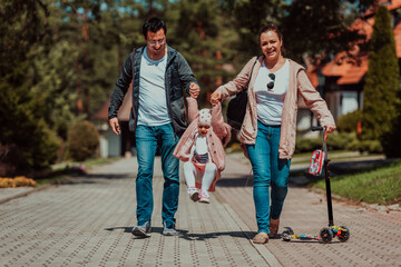 Obraz premium Family fun in the park. Happy family spending time in park and playing with their daughter