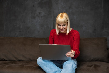 Young girl or woman with a cool attitude freelancer working from home for a foreign modern company...